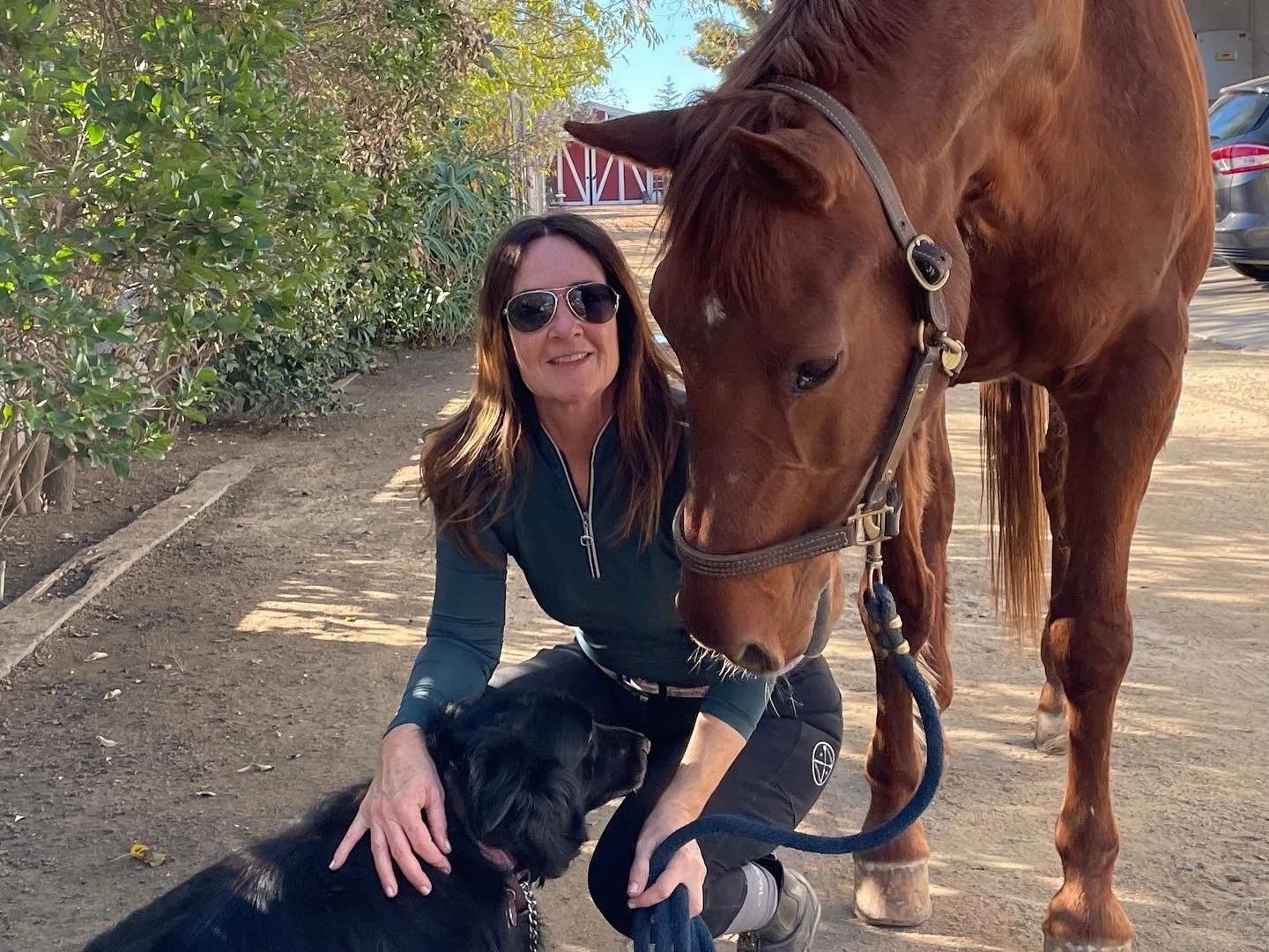 Marce with her horse Helen and her dog at the stables