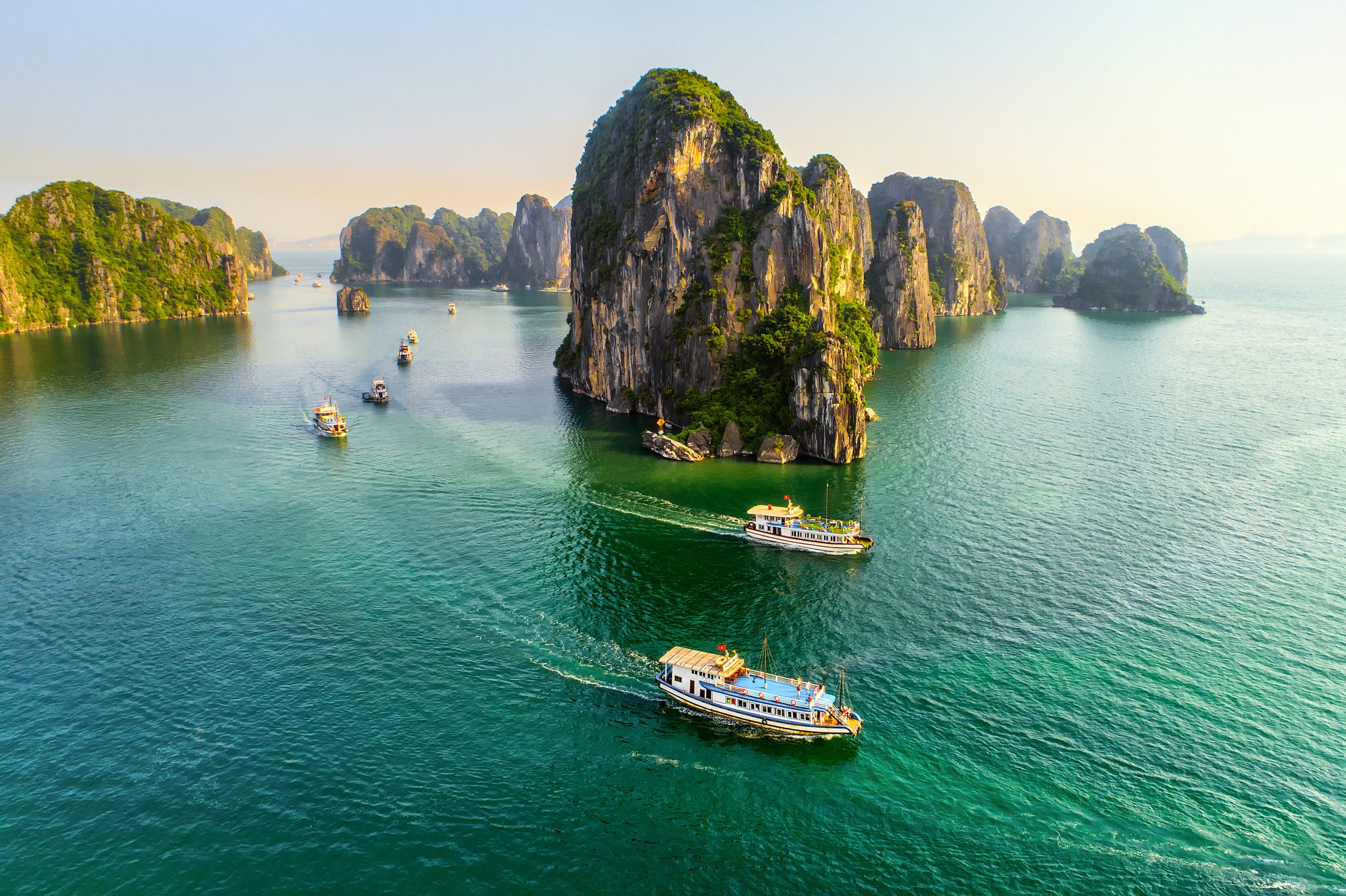 Boats among the karsts of Ha Long Bay
