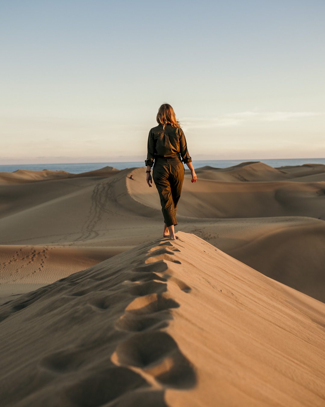 Walking a dune ridge in the Moroccan Sahara